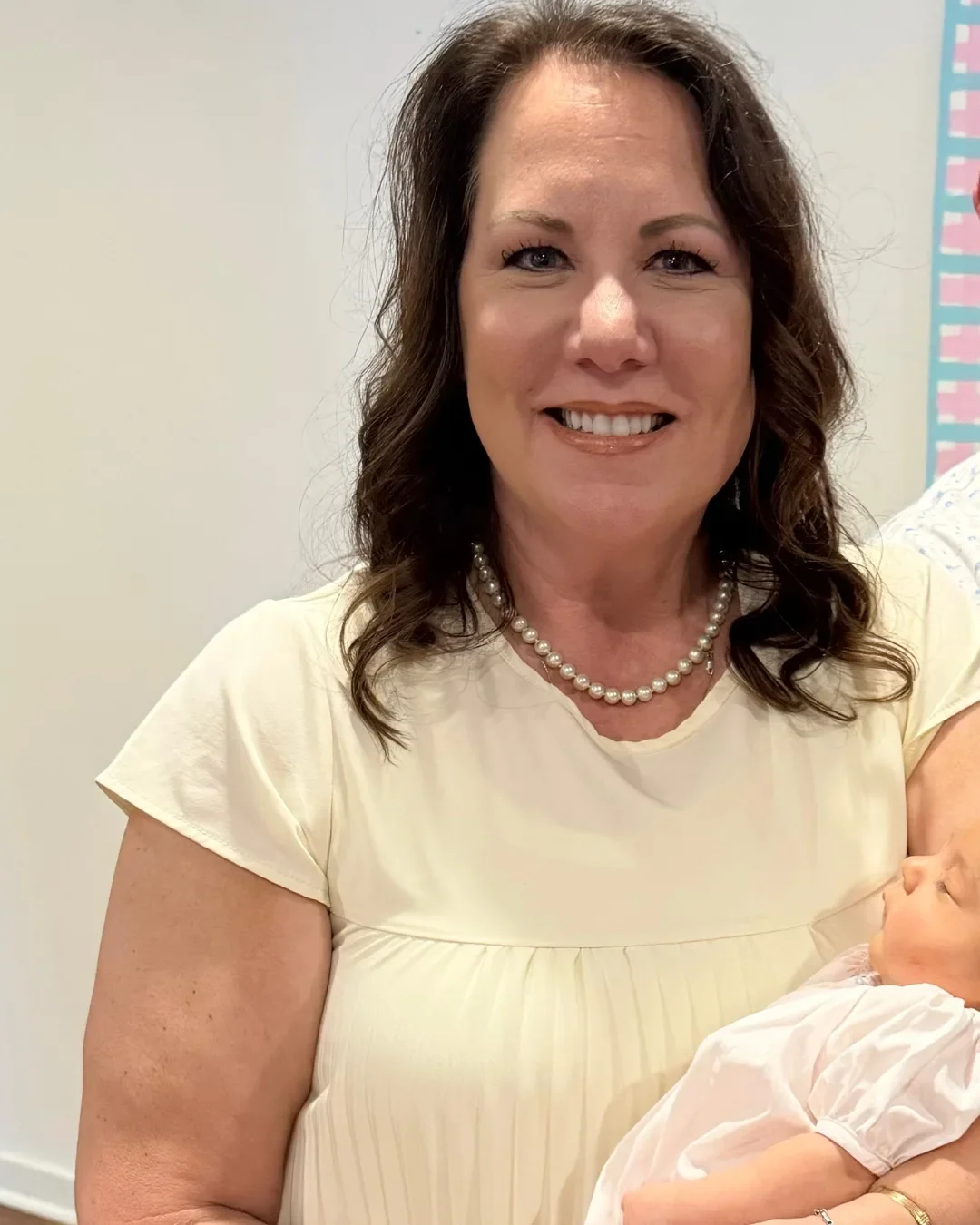 SimpleFix weight loss patient after treatment, smiling and holding her grandchild